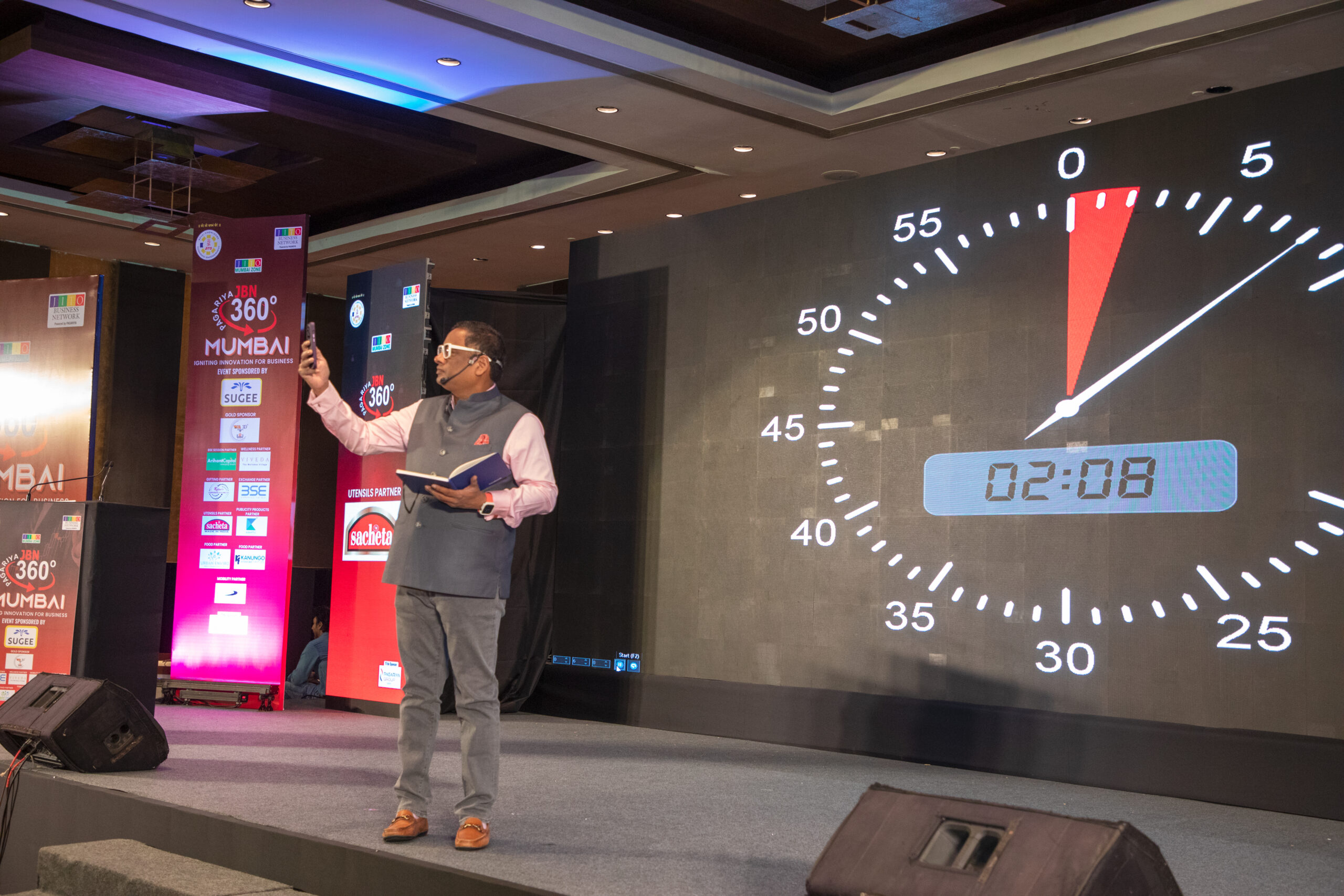 Sampath Iyengar speaking on stage at JBN 360 Mumbai Jain Business Network