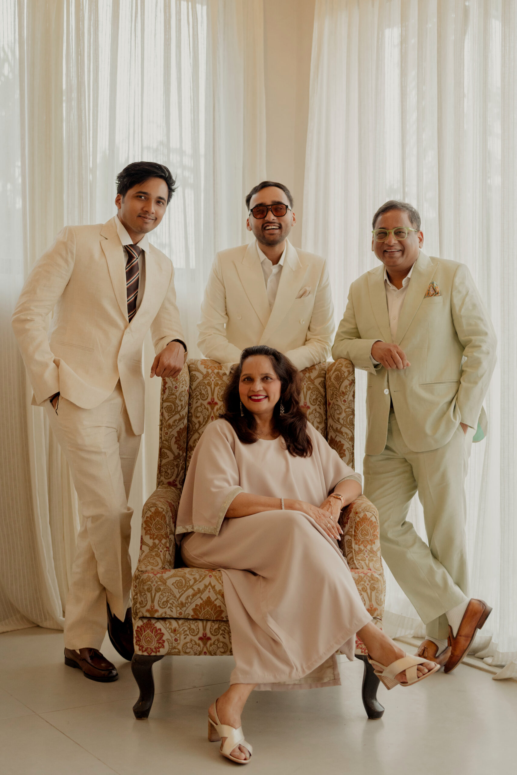 Sampath Iyengar Nomita Iyengar Aniket Iyengar and Kunal Iyengar family portrait Goa wedding cream outfits