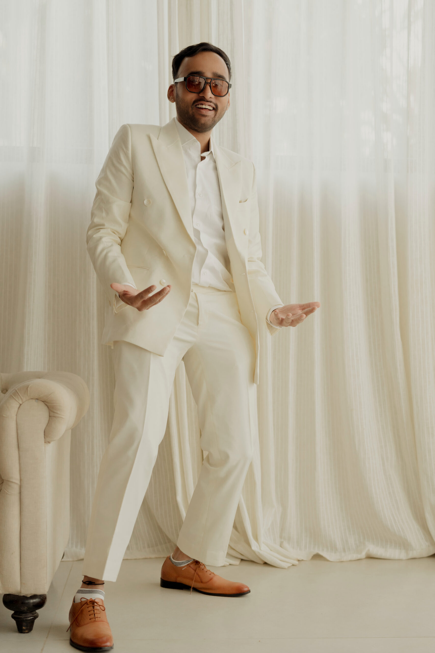 Kunal Iyengar music composer son of Sampath Iyengar in cream suit sunglasses Goa wedding