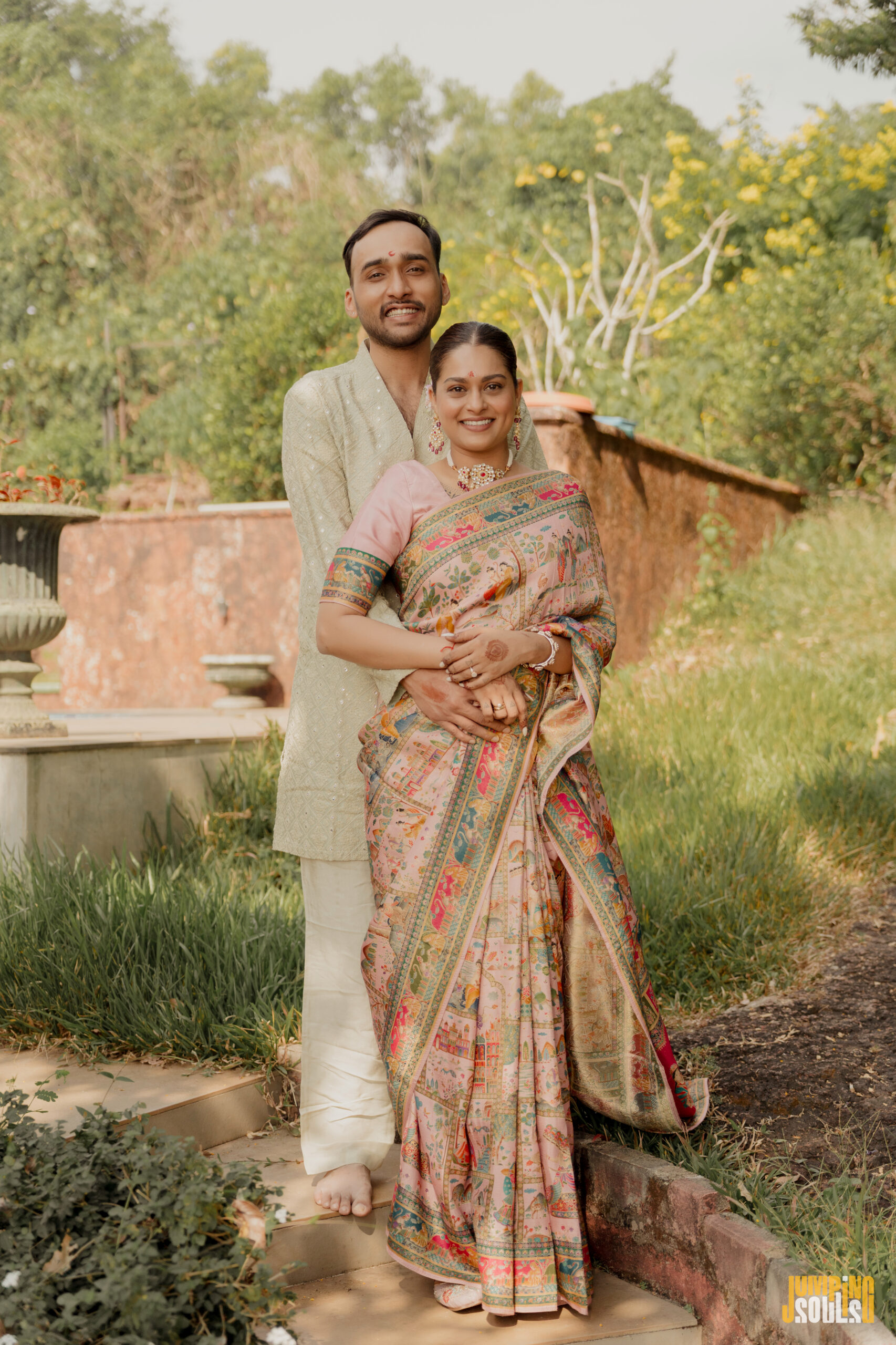 Kunal Iyengar and Rachel D'Costa wedding portrait garden Goa cream sherwani pink saree